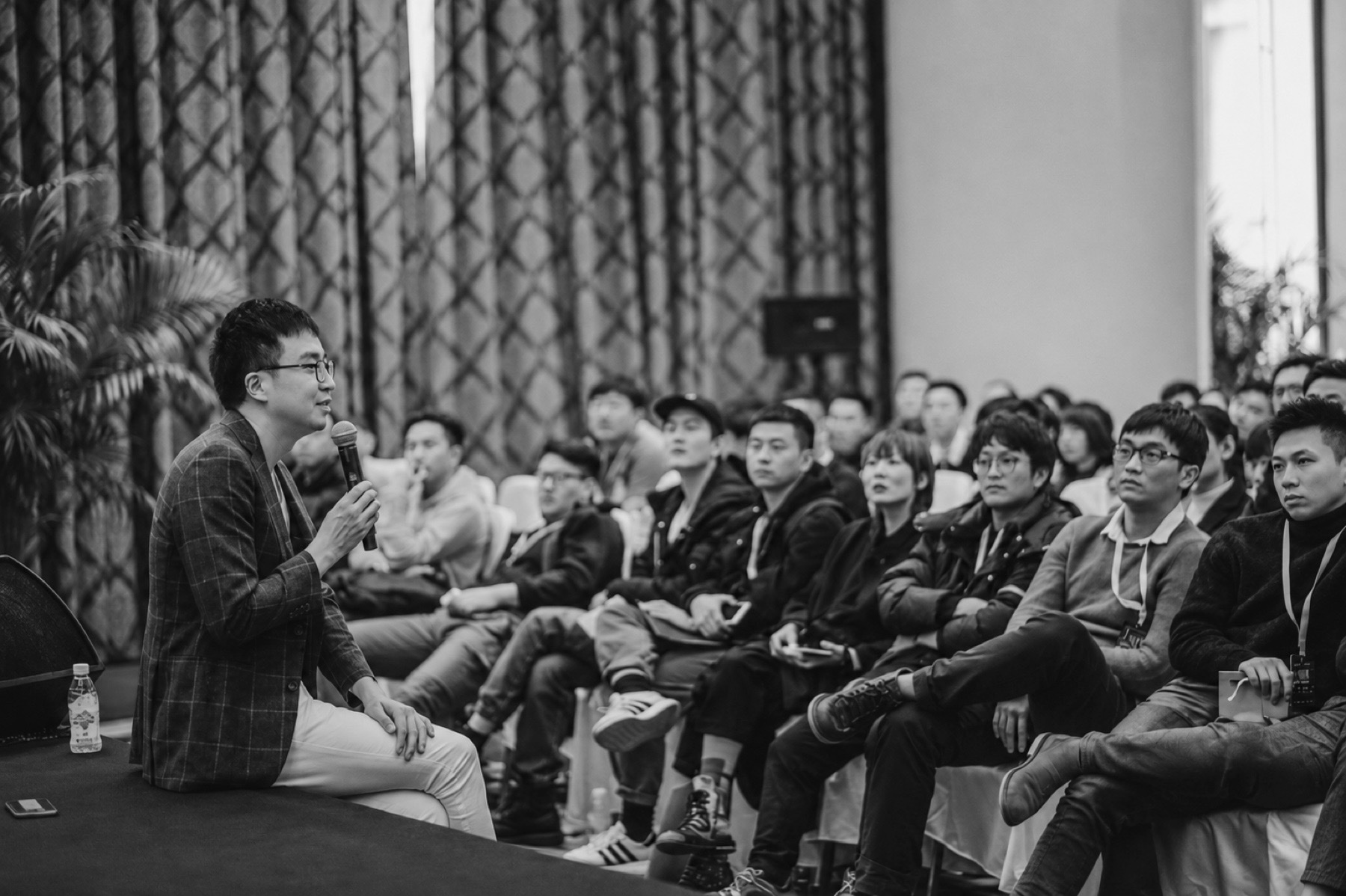 Dr. Aries Tao speaking at a photography event